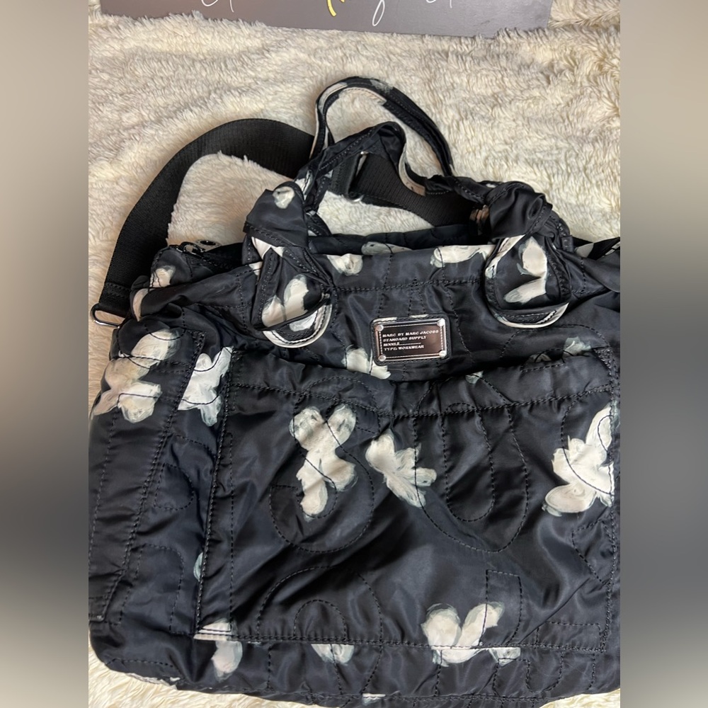 Marc Jacob’s black floral diaper bag with changing pad.